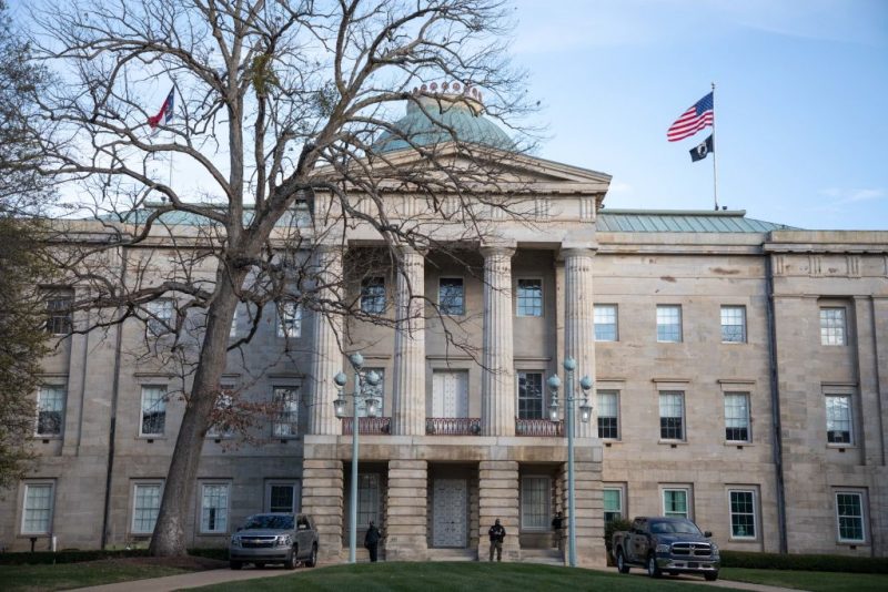Law enforcement stand guard outside of the state capitol building in downtown Raleigh, North Carolina, on January 17, 2021, during a nationwide protest called by anti-government and far-right groups supporting US President Donald Trump and his claim of electoral fraud in the November 3 presidential election. - The FBI warned authorities in all 50 states to prepare for armed protests at state capitals in the days leading up to the January 20 presidential inauguration of President-elect Joe Biden. (Photo by Logan Cyrus / AFP) (Photo by LOGAN CYRUS/AFP via Getty Images)