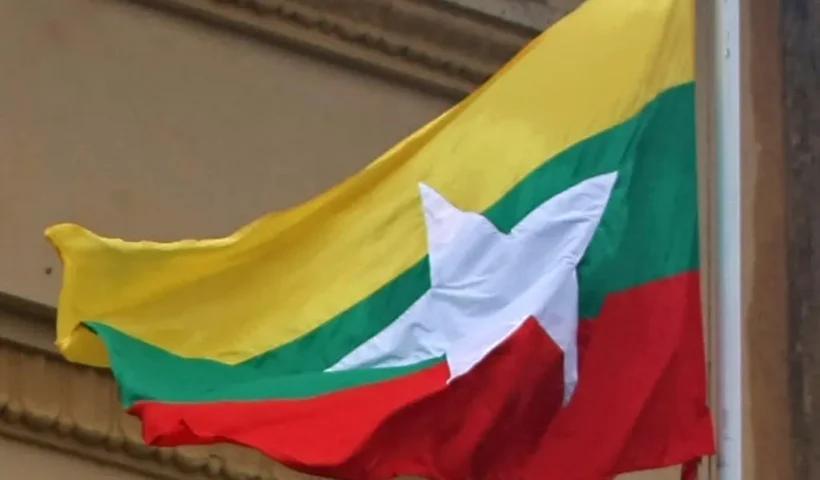 Myamar's new national flag flutters at Yangon City Hall on October 21, 2010. Myanmar's junta began using the new national flag as it gears up for a rare election next month that critics say is a charade aimed at putting a civilian facade on military rule. AFP PHOTO/Soe Than Win (Photo by Soe Than WIN / AFP) (Photo by SOE THAN WIN/AFP via Getty Images)