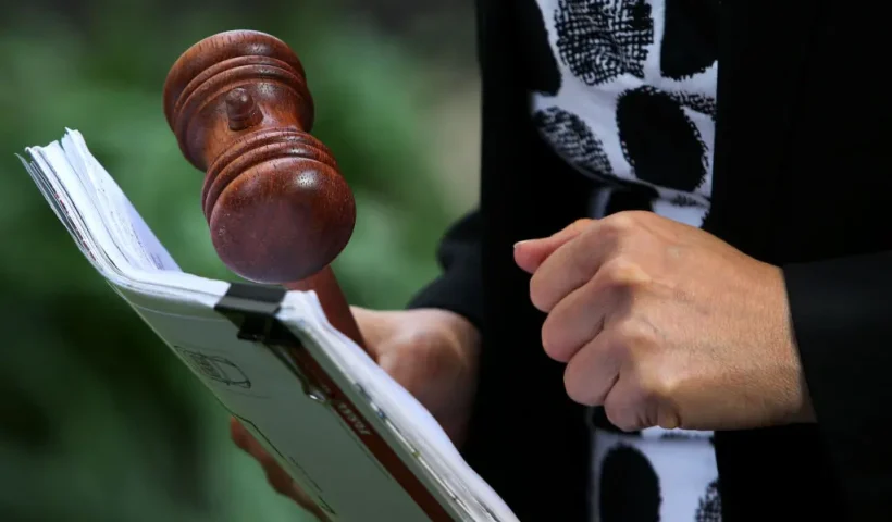 SYDNEY, AUSTRALIA - MAY 08: Auctioneer Karen Harvey holds a gavel during an auction of a residential property in Hurlstone Park on May 08, 2021 in Sydney, Australia. Property prices continue to rise across Australia with house prices up almost 27 percent compared to five years ago. Record low interest rates have also seen a surge in home loan applications in the last year. (Photo by Lisa Maree Williams/Getty Images)