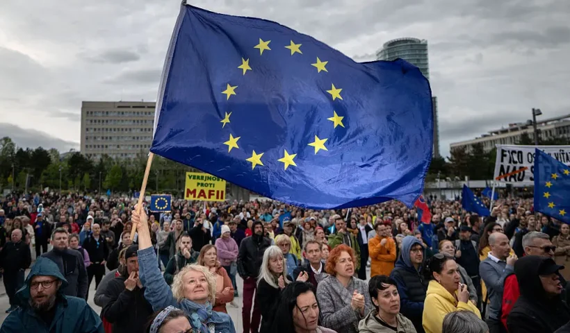 A woman holds an EU flag as people take part in an anti-government protest organized by political activists of the Peace in Ukraine organization under the slogan "No to the Russian Law", against a planned law intended to complicate the work of non-governmental organizations on April 24, 2025, in Bratislava, Slovakia. (Photo by TOMAS BENEDIKOVIC / AFP) (Photo by TOMAS BENEDIKOVIC/AFP via Getty Images)