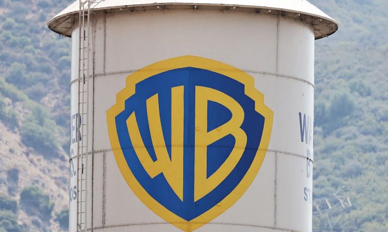 BURBANK, CALIFORNIA - SEPTEMBER 12: The Warner Bros. logo is displayed on a water tower at Warner Bros. Studio on September 12, 2025 in Burbank, California. Media giant Paramount Skydance is reportedly preparing a bid to purchase Warner Bros. Discovery, including its movie studio and cable networks. (Photo by Mario Tama/Getty Images)