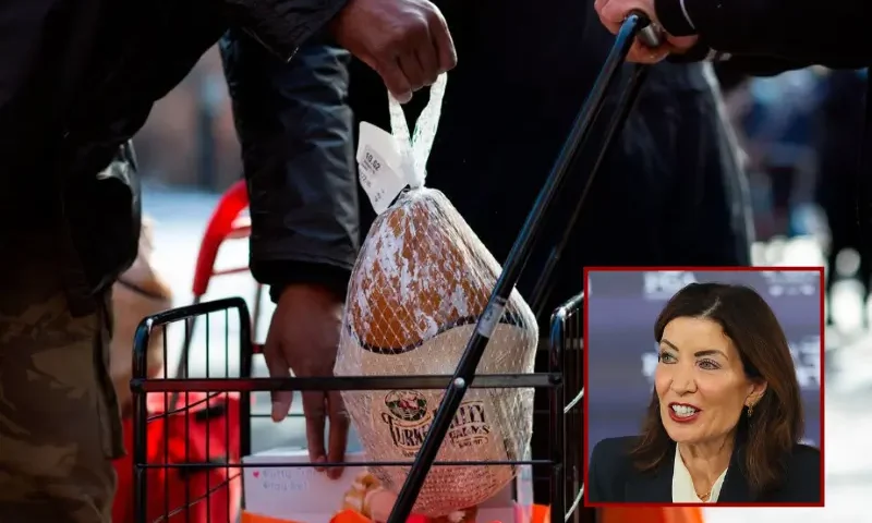 A Volunteer holds a turkey during a giveaway organized by Food Bank For New York City at Highbridge Houses in the Bronx on December 19, 2020 in New York. (Photo by Kena Betancur / AFP) (Photo by KENA BETANCUR/AFP via Getty Images) / New York Governor Kathy Hochul attends a press conference beside the Black Course at Bethpage State Park Golf Course on September 17, 2025 in Farmingdale, New York. The 2028 KPMG Women's PGA and 2033 PGA Championship tournaments will be played on the course. (Photo by Bruce Bennett/Getty Images)