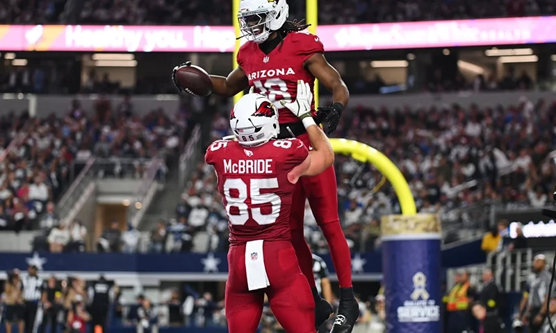 Arizona Cardinals’ Marvin Harrison Jr. (18) and Trey McBride (85) celebrate Harrison Jr.s’ touchdown catch in the first half of an NFL football game against the Dallas Cowboys Monday, Nov. 3, 2025, in Arlington, Texas. (AP Photo/Jessica Tobias)