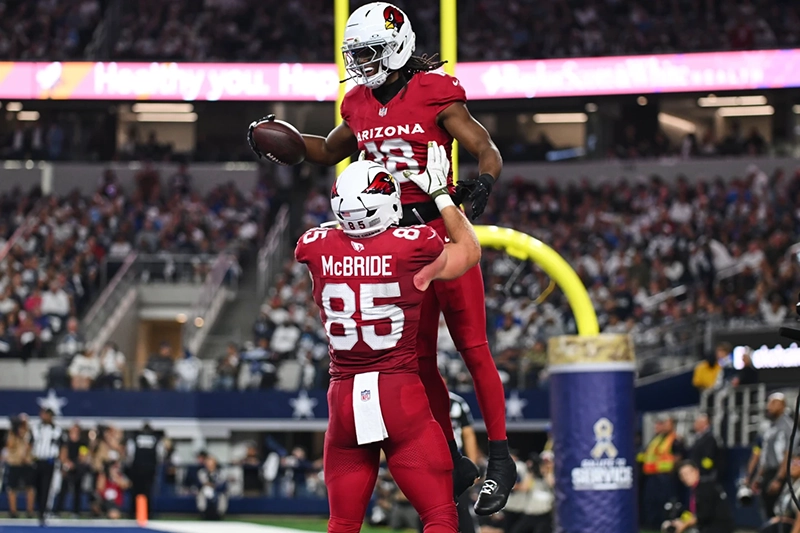 Arizona Cardinals’ Marvin Harrison Jr. (18) and Trey McBride (85) celebrate Harrison Jr.s’ touchdown catch in the first half of an NFL football game against the Dallas Cowboys Monday, Nov. 3, 2025, in Arlington, Texas. (AP Photo/Jessica Tobias)