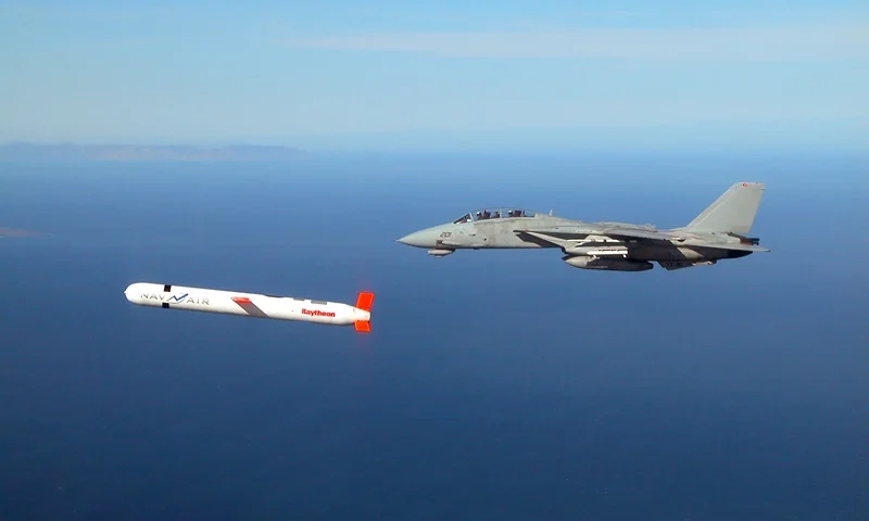 A Tactical "Tomahawk" Block IV cruise missile is escorted by a Navy F-14 "Tomcat" fighter during a controlled test over the Naval Air Systems Command (NAVAIR) western test range complex in southern California. The Tactical Tomahawk, scheduled to join the fleet in 2004, is the next generation of Tomahawk cruise missile and it adds the capability to reprogram the missile while in-flight to strike any of 15 preprogrammed alternate targets or redirect the missile to any Global Positioning System (GPS) target coordinates. Warplanes from a US-British coalition bombed communications facilities in the south of the country after an Iraqi military jet violated the no-fly zone, the US military said 22 November. AFP PHOTO/US NAVY HO (Photo by US NAVY / AFP) (Photo by -/US NAVY/AFP via Getty Images)