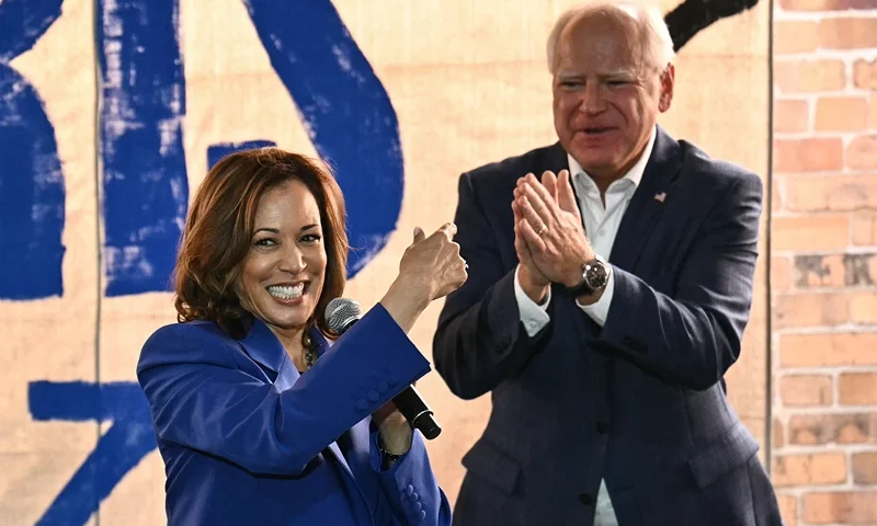 US Vice President and Democratic presidential candidate Kamala Harris (L) speaks as her running mate Minnesota Governor Tim Walz looks on during a stop on their campaign bus tour in Rochester, Pennsylvania, on August 18, 2024. Harris embarked on a bus tour of the potentially election-deciding state of Pennsylvania on Sunday, as she keeps up the momentum before her star turn at the Democratic National Convention in Chicago. (Photo by ANGELA WEISS / AFP) (Photo by ANGELA WEISS/AFP via Getty Images)