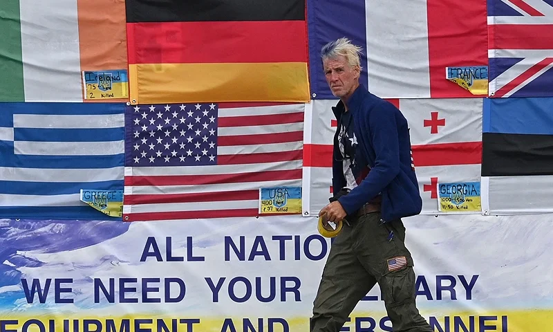 TOPSHOT - This photograph taken on Independence Square in Kyiv on June 23, 2022 shows US citizen Ryan Wesley Routh sticking up national flags of the countries helping Ukraine. US media said it was Routh, 58, who was arrested after US Secret Service agents "opened fire on a gunman" carrying an AK-47 style rifle near the boundary of Donald Trump's Florida golf course where the former president was golfing on September 15, 2024. (Photo by Sergei SUPINSKY / AFP) (Photo by SERGEI SUPINSKY/AFP via Getty Images)