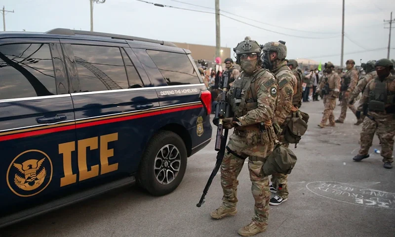 Immigration and Customs Enforcement (ICE) agents armed with less-lethal weapons gather outside an ICE processing center during a protest in Broadview, Illinois, on September 19, 2025. US President Donald Trump ordered increased federal law enforcement presence in Illinois and stepped-up immigration enforcement actions by the Department of Homeland Security. (Photo by OCTAVIO JONES / AFP) (Photo by OCTAVIO JONES/AFP via Getty Images)
