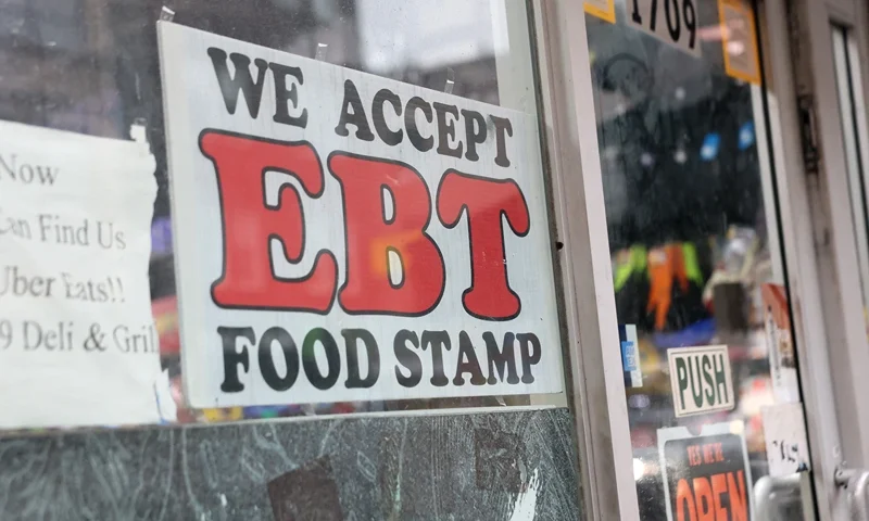 NEW YORK, NEW YORK - OCTOBER 30: An EBT sign is displayed on the window of a grocery store on October 30, 2025 in the Flatbush neighborhood of the Brooklyn borough in New York City. Supplemental Nutrition Assistance Program (SNAP) benefits and other assistance are set to stop on November 1st amid a federal government shutdown that has been going on for 29 days and is the second-longest shutdown in the nation's history. New York Gov. Kathy Hochul declared a state of emergency for extra emergency funds and personnel to be deployed, as SNAP payments will be suspended. About 42 million Americans are expected to lose access to their benefits. (Photo by Michael M. Santiago/Getty Images)