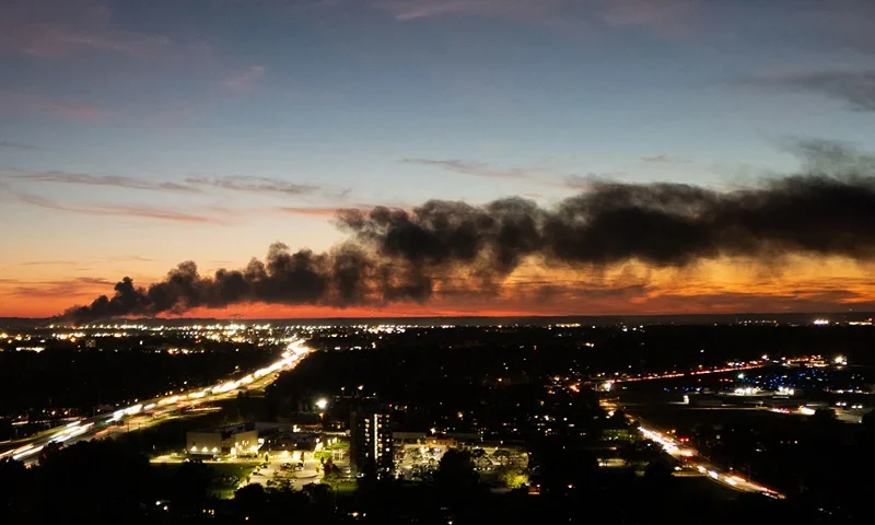 TOPSHOT - Smoke rises from the site of a UPS cargo plane crash near the UPS Worldport at Louisville Muhammad Ali International Airport in Louisville, Kentucky, on November 4, 2025. A UPS cargo plane crashed on the evening of November 11 near the Louisville International Airport shortly after takeoff, the US Federal Aviation Administration (FAA) said, as local media in the Kentucky city aired video of a large plume of smoke rising above the facility."UPS Flight 2976 crashed around 5:15 p.m. local time," the FAA said, identifying the aircraft as a McDonnell Douglas MD-11 headed to Hawaii. (Photo by LEANDRO LOZADA / AFP) / ALTERNATE CROP (Photo by LEANDRO LOZADA/AFP via Getty Images)