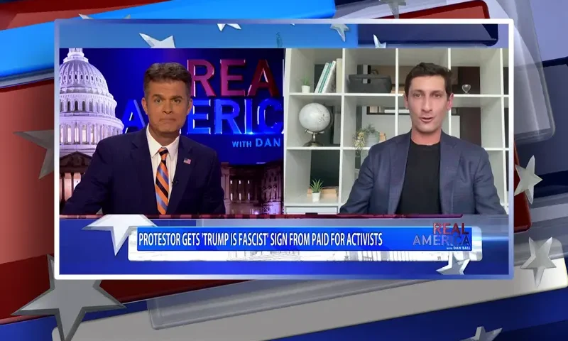 Video still from Real America on One America News Network showing a split screen of the host on the left side, and on the right side is the guest, Adam Swart.